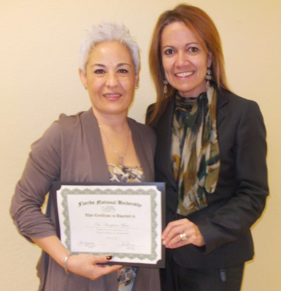 Ms. Carol Romero presents Dr. Mora with a certificate of appreciation