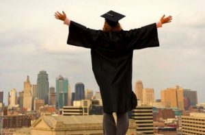 Graduate standing on rooftop
