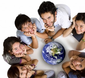 students huddled around globe