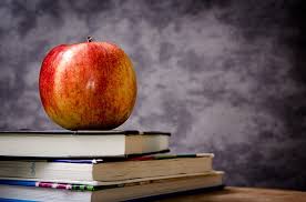 Apple on top of books