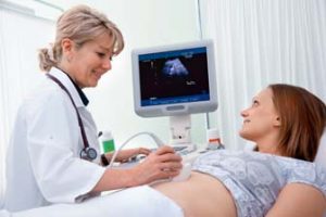 Docter performing Diagnostic Medical Sonography on patient 