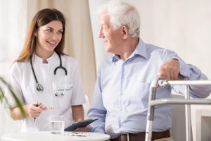 Nurse having conversation with senior citizen