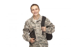 U.S. soldier with a backpack and books