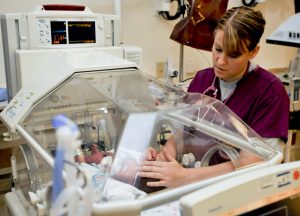 Nurse examines new born baby