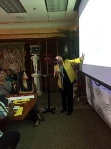 MSN program director Dr. Cesar points at projection screen while giving a presentation