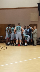 The Florida NationalUniversity Men's Basketball team huddle during a timeout. 