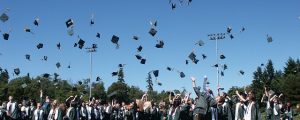 FNU graduates throwing caps in the air at ceremony