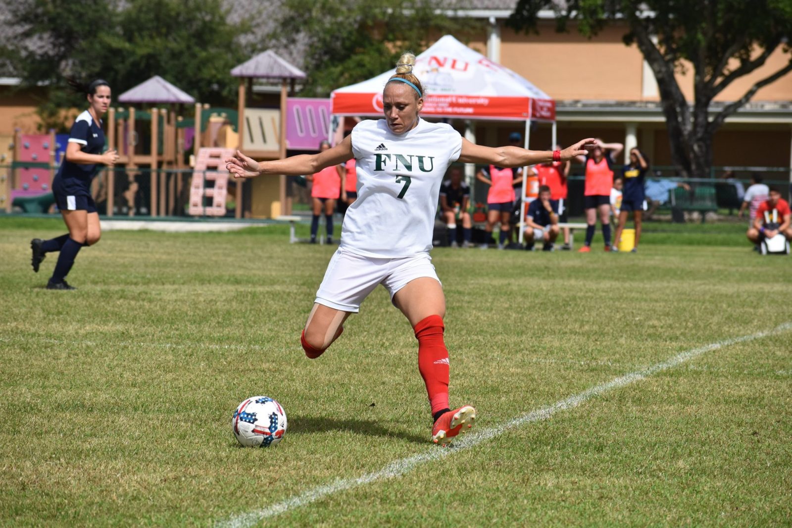 Fnu soccer player shooting the ball during the game against Warner University