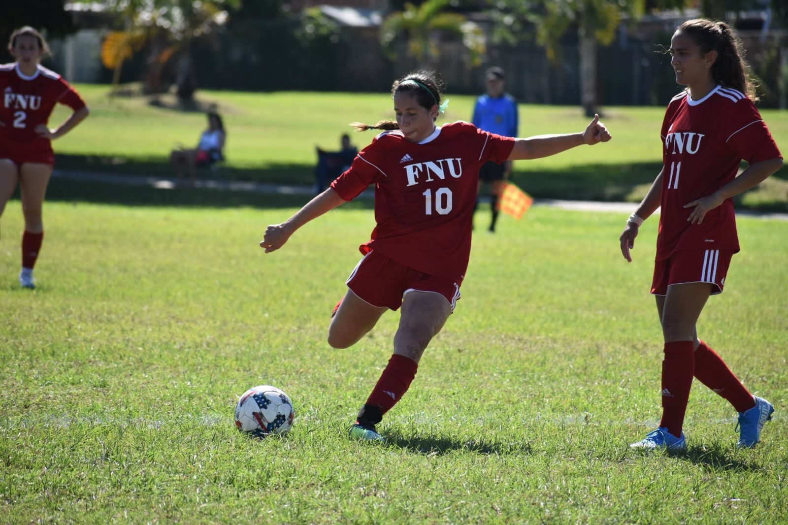 FNU soccer player Juliana Oliveira Shooting the ball