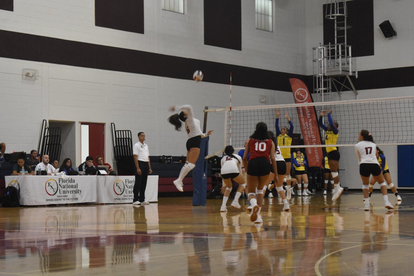 Fnu Volleyball Player Attacking the ball and opponents trying to block