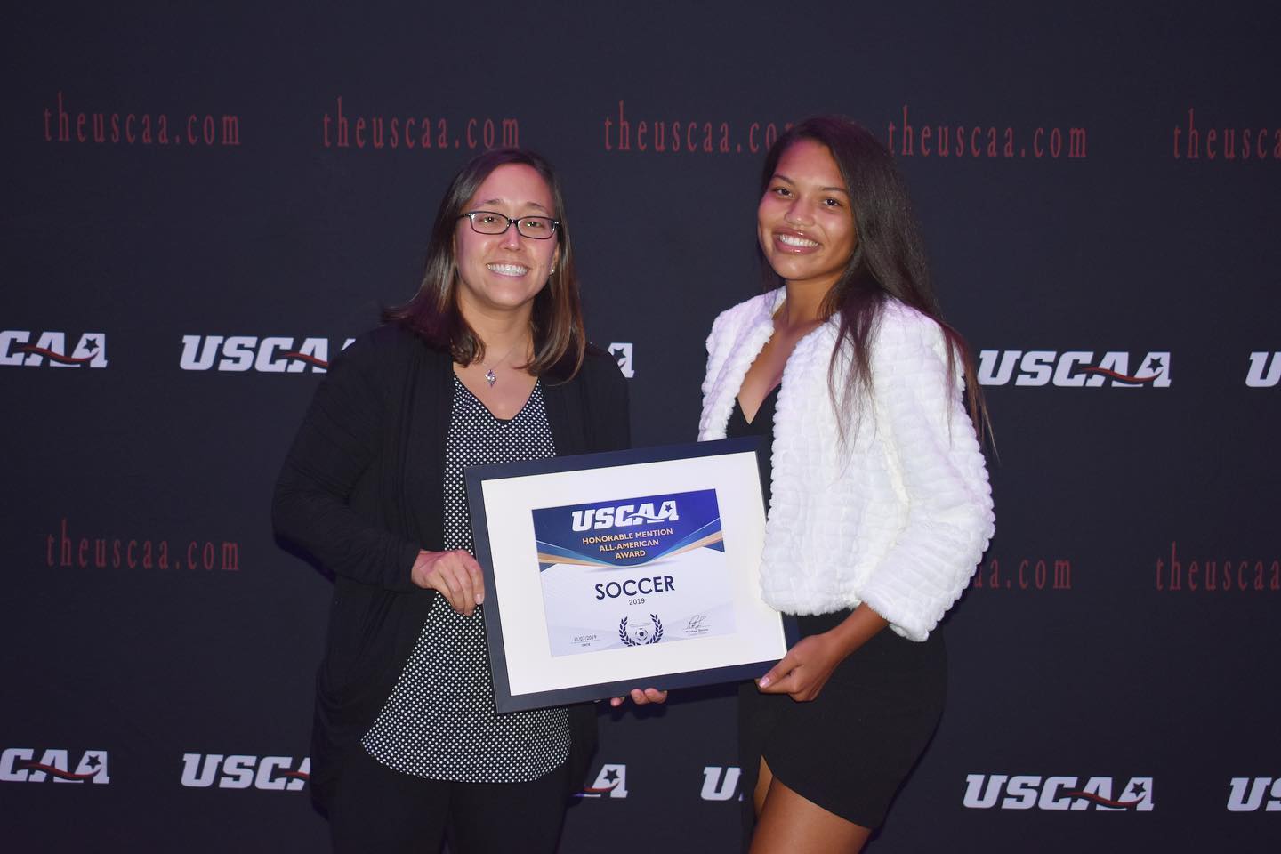 Women's soccer player Dominique Mosley Receiving the All-American second team award