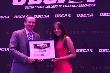 Women's soccer player Noriann Gaviria Receiving the All-Academic award