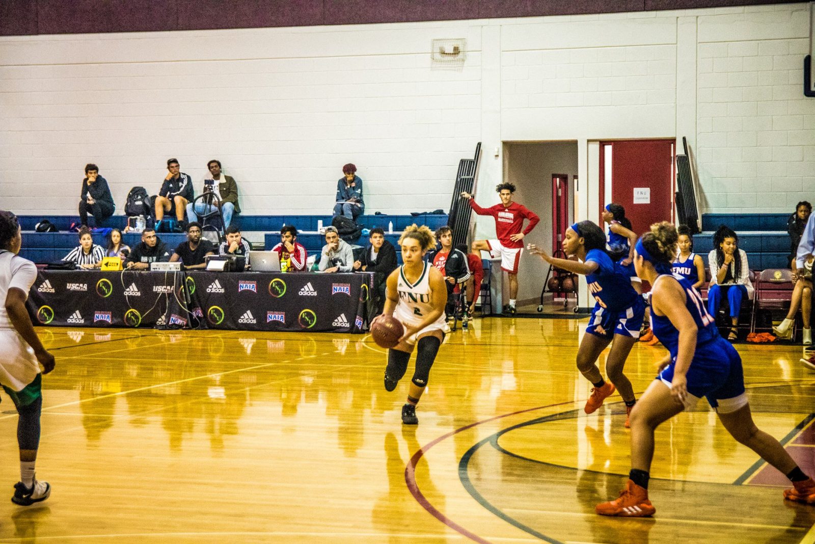Women's basketball player Adria Stewart dribbling the ball