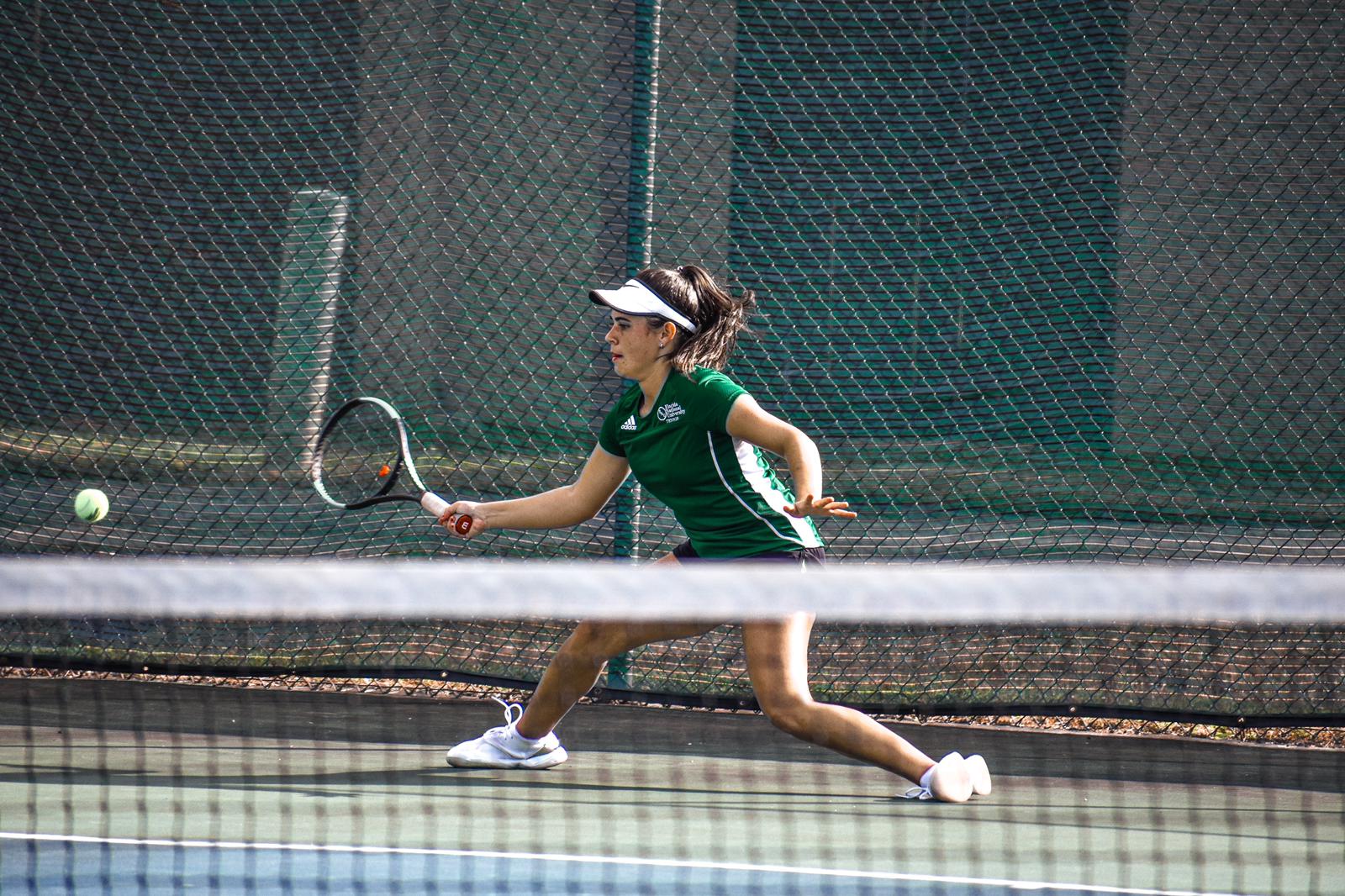 FNU tennis player Candela hitting the ball in the Game