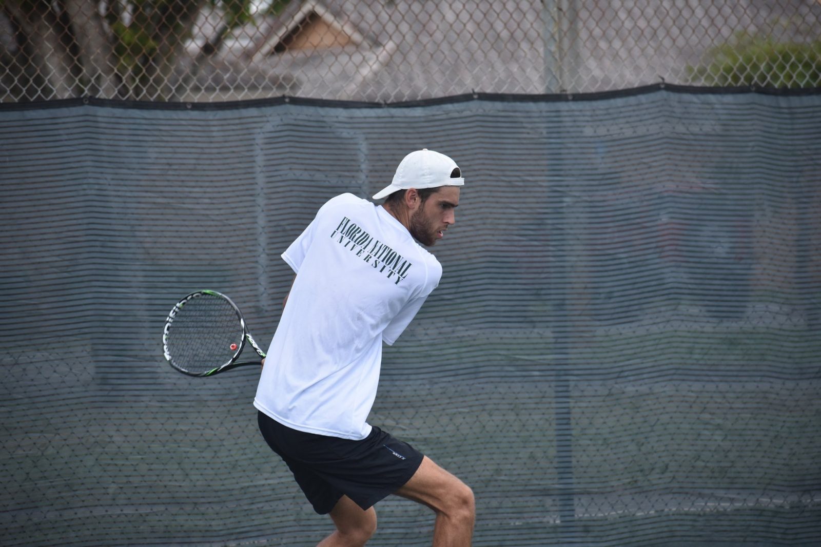 FNU tennis player hitting the ball
