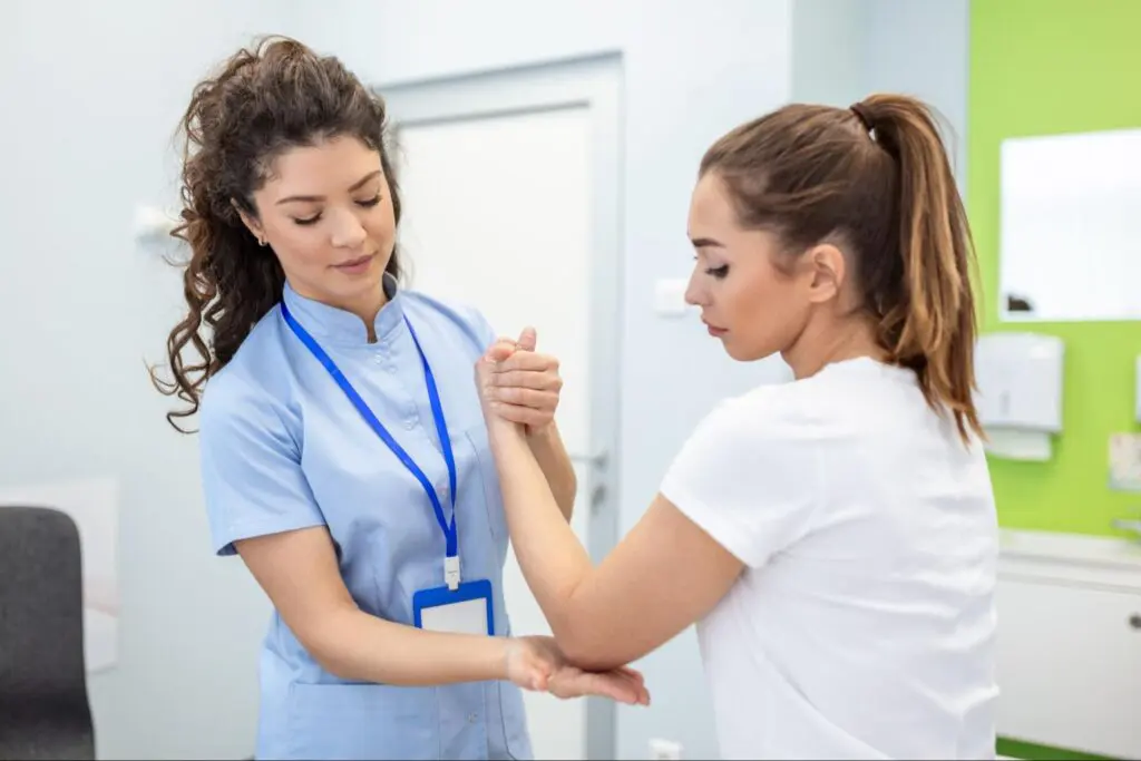 A physical therapist checking a patient’s range of motion