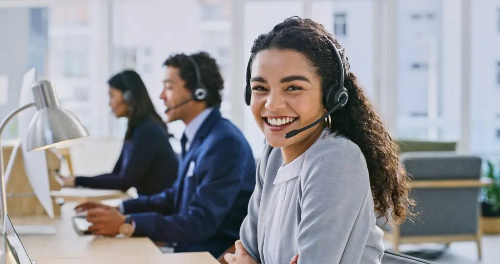 Young woman in a headset providing support services, showcasing a career path in business administration.