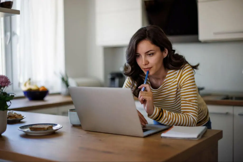 Young woman reading about law degree programs on computer