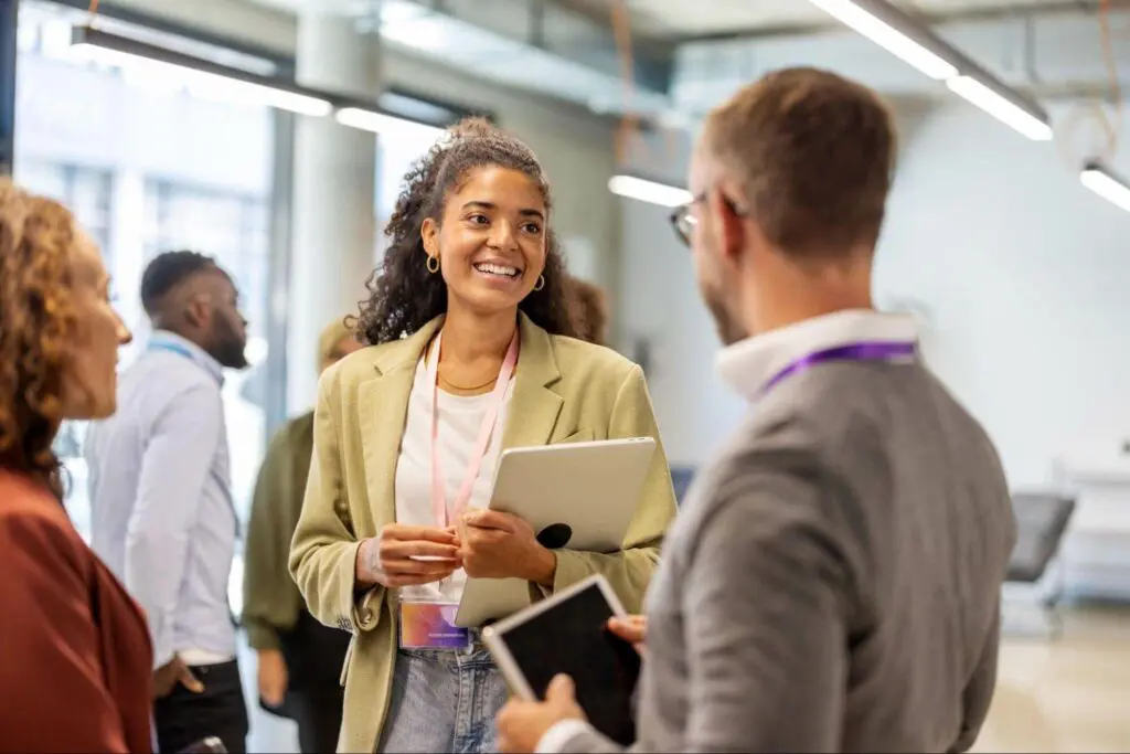 Young professional woman networking at an event, focused on career development