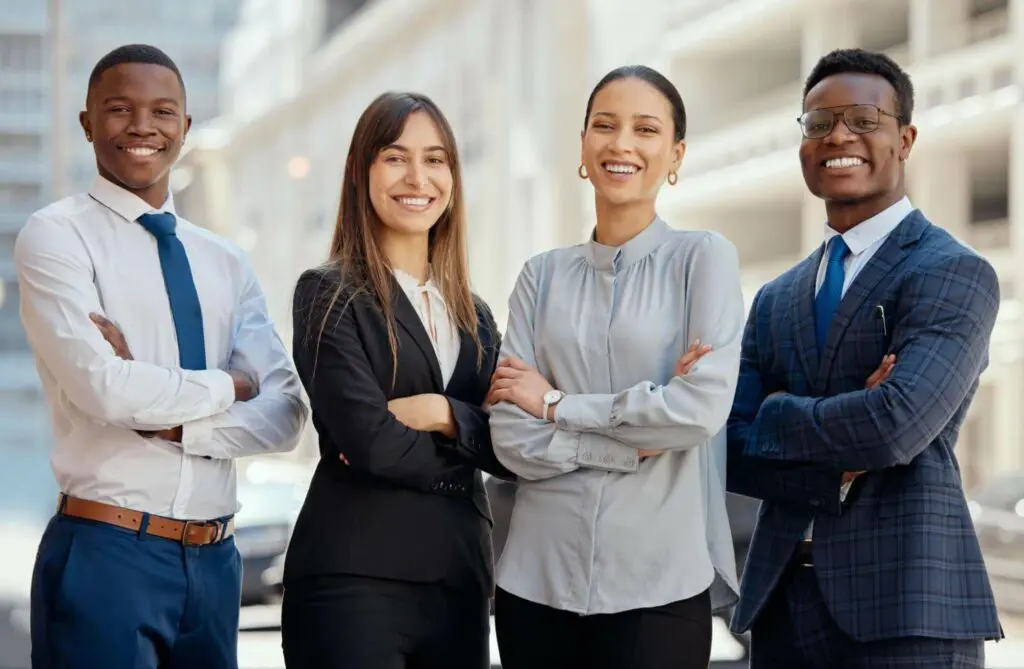Diverse group of students at law school smiling with arms folded