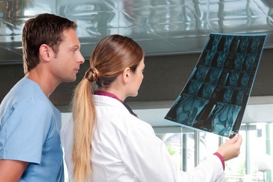 nurse and doctor examining x-ray