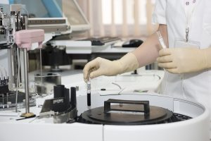 laboratory assistant filling vials