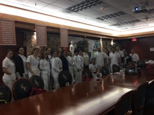 Nursing students pose at the golden Room