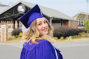 girl in cap and gown at graduation