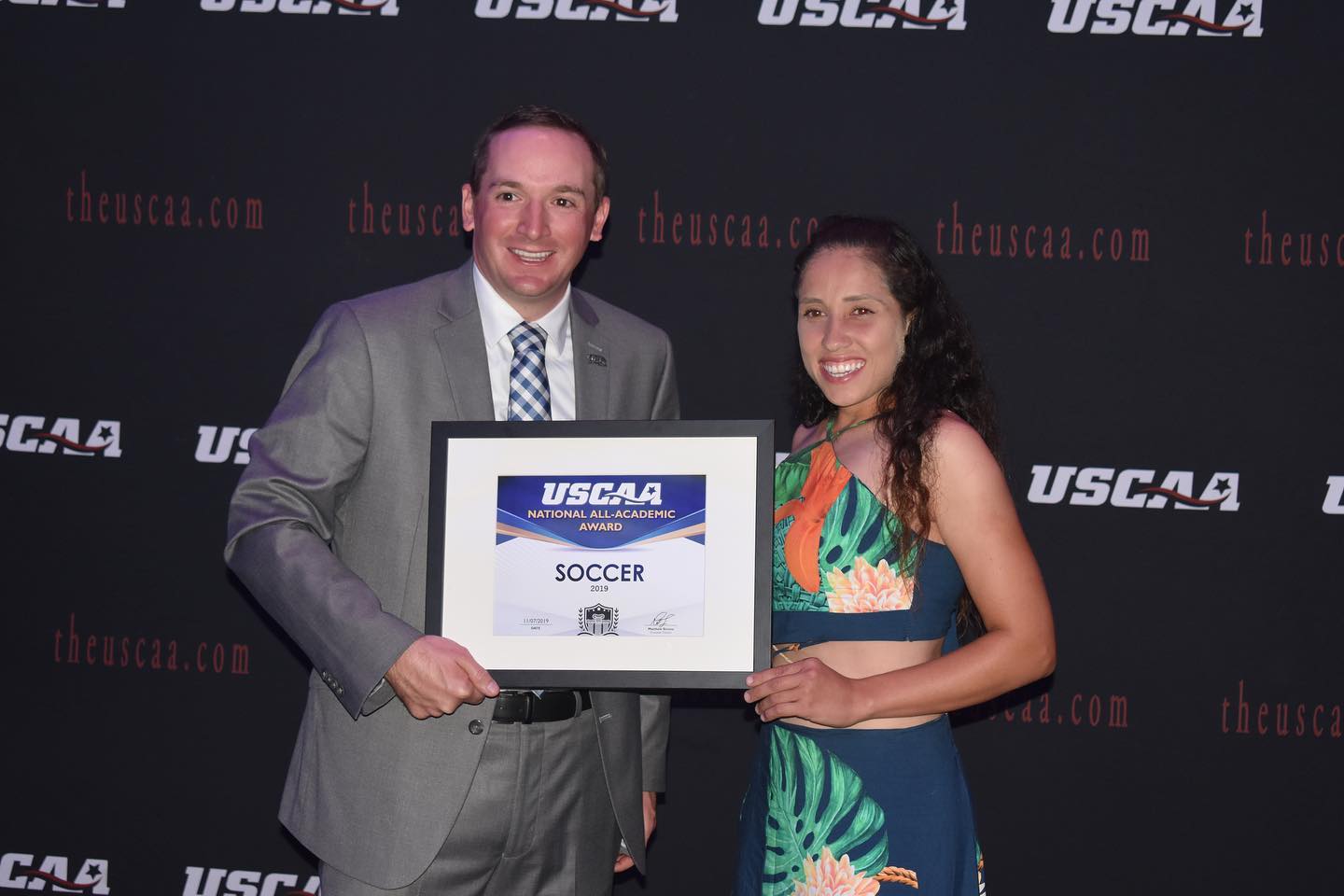Women's soccer player Juliana Oliveira Receiving the All-Academic award
