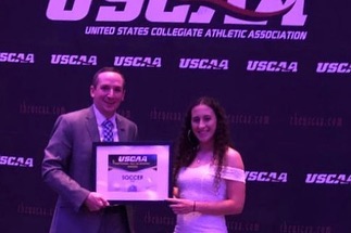 Women's soccer player Paola Mejia Receiving the All-Academic award