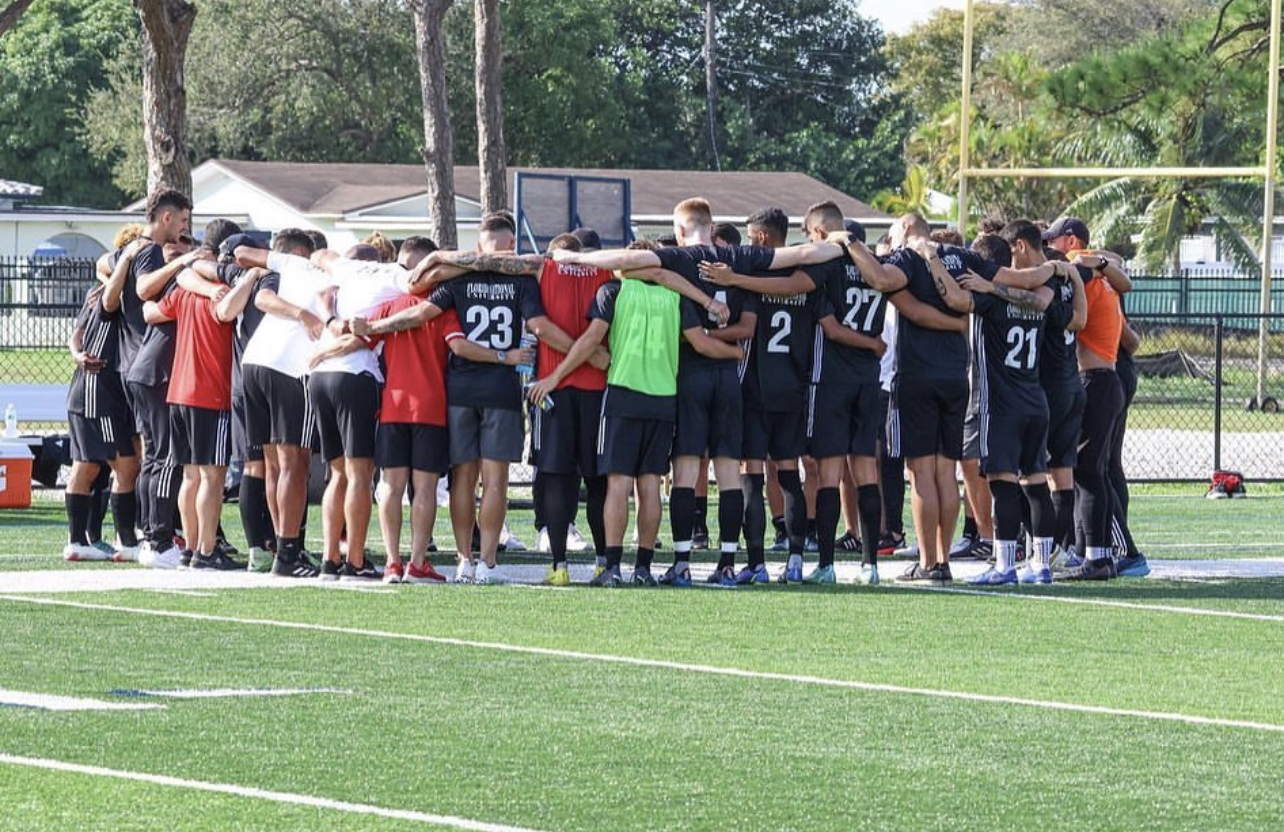FNU men's soccer share a post-game huddle after 4-2 win over Life University.