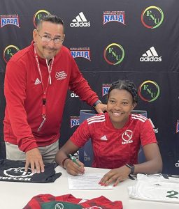FNU head women's soccer coach Giovanni De la Rosa and goalkeeper Nahomie Ambroise at Ambroise's signing.