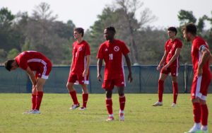 FNU men's soccer players on the soccer field at Warner University.