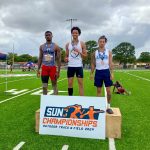 Ivan Rodriguez on the podium after being crowned the Sun Conference champion in the triple jump.